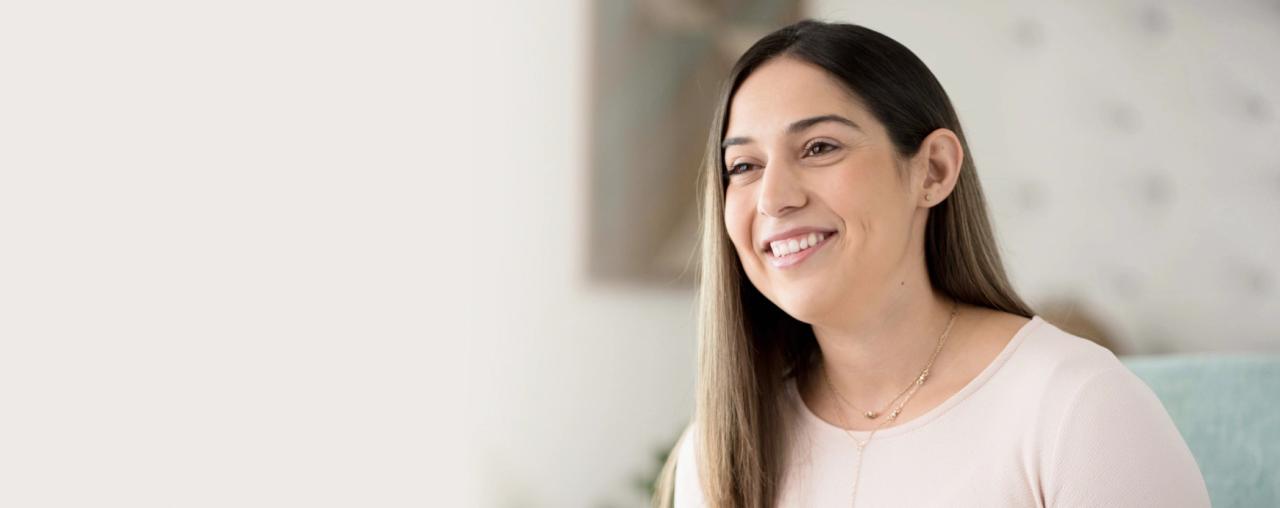 woman with long brown hair smiling because she has found debt relief