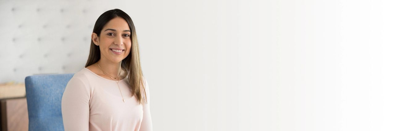 woman with long brown hair smiling because she has found debt relief