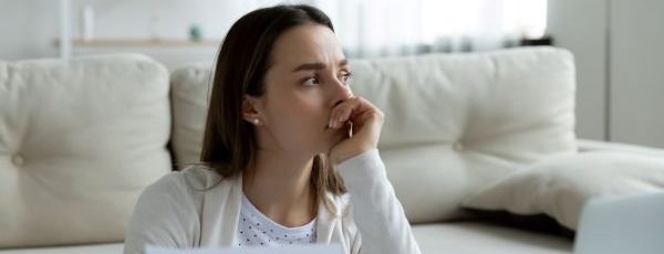 Young woman thinking of financial problems